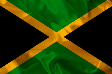 colored national flag of the modern state of Jamaica on beautiful pleated silk fabric, concept of tourism, economic and political development, global business