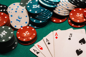 four of a kind of aces in poker on the gaming table with chips