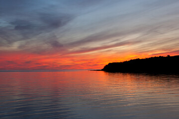 Beautiful cloudscape landscape sunset from the beach. red sunset and clouds