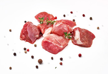 Sliced mutton meat with thyme herb and mix peppers isolated on white. Pieces of raw mutton meat.