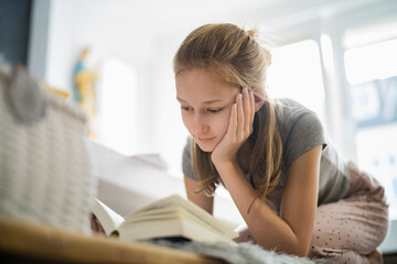 Girl reading a book at home