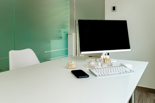 Smart phone with computer on desk in dentist's office