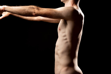 Side view of a muscular naked man with kyphosis and lordosis trying to correct the bad posture....