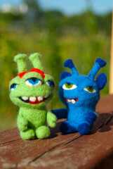 Two felted toy monsters