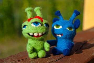 Two handmade felted toy monsters