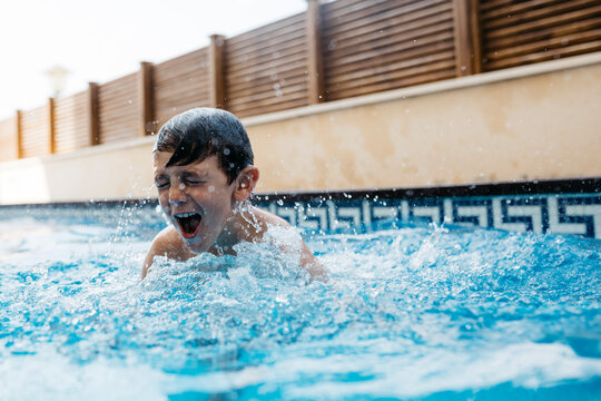 Boy enjoying in swimming pool during summer