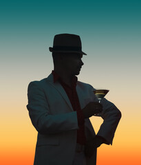 Romantic man enjoying a glass of wine and beautiful sunset view. Man drinking glass of cocktail. Happy life moments. Cheers at sunset.