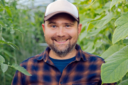 Portrait of smiling farmer in a greenhouse