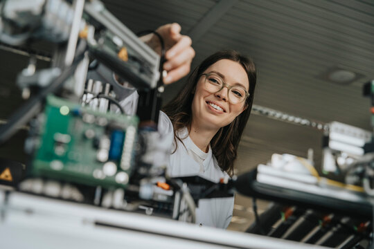 Close-up of female scientist installing machinery in laboratory