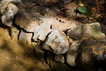 Untreated rough natural stone in everyday environment, gardening and landscaping