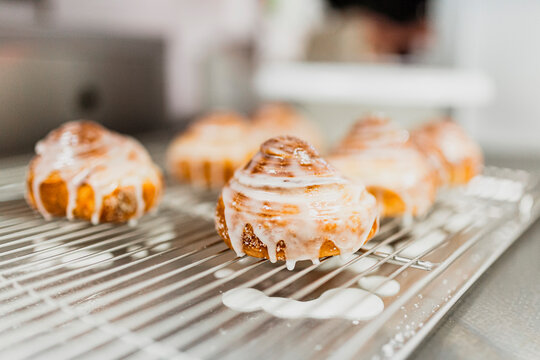 Cinnamon rolls on baking sheet at kitchen counter
