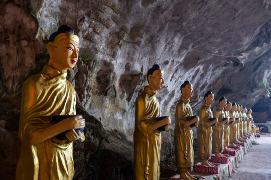 Myanmar, Kayin State, Hpa-an, Row of Buddha statues inside Saddan Cave