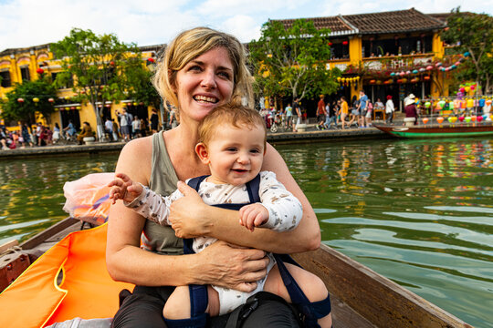 Vietnam, Hoi An, Mother with baby son in boat