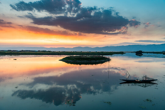 Myanmar, Shan state, Nampan, Traditional rowing boat on Inle lake at sunset