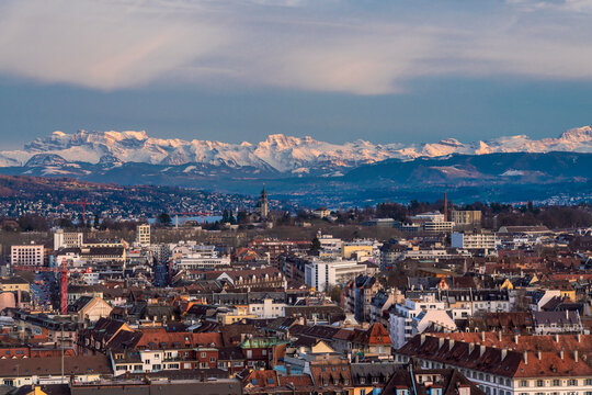 Switzerland, Zurich, Cityscape with snow covered mountains in background, aerial view