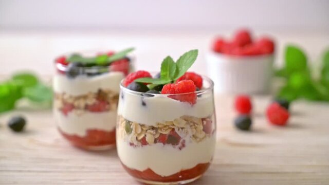 homemade raspberry and blueberry with yogurt and granola - healthy food style