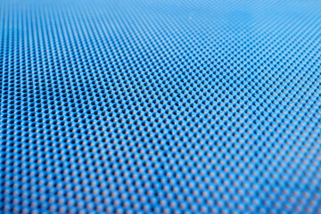 Blue plastic background with holes. Manufacture of plastic products with various textures and patterns.