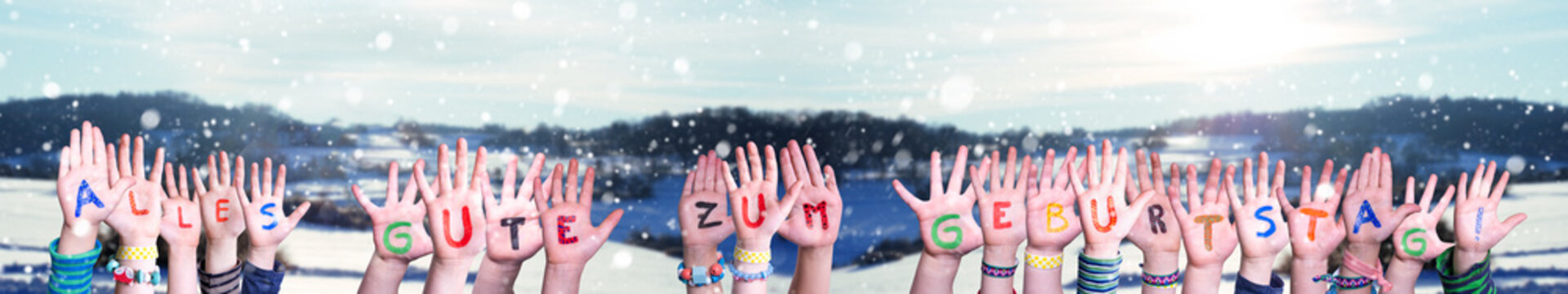 Children Hands Building Colorful German Word Alles Gute Zum Geburtstag Means Happy Birthday. Snowy Winter Background With Snowflakes