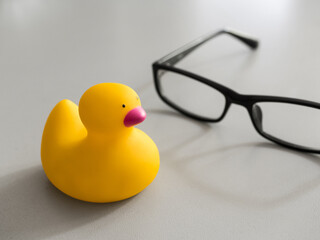 Toy yellow rubber duck on the desktop. Opposition symbol and political struggle