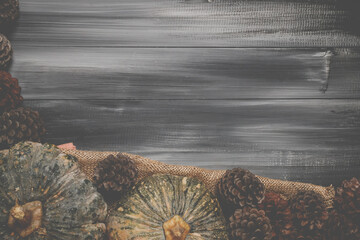 Fall Thanksgiving and Halloween pumpkins over dark wood table background shot from directly above.