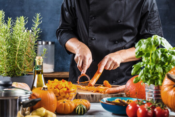 cropped shot of chef chopping ingredients for pumpkin soup