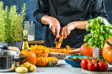 cropped shot of chef chopping ingredients for pumpkin soup