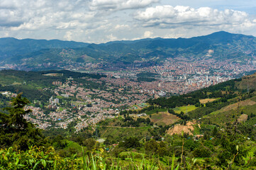 Fototapeta na wymiar View of the City of Medellin, Antioquia / Colombia Surrounded by Mountains with a Cloudy Sky