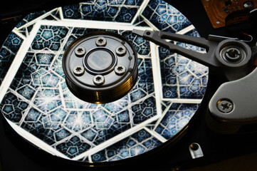closeup of computer open hard disk drive with colored abstract effect reflected