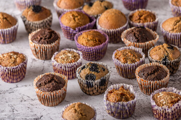 Sweet cakes or cupcakes on light marble background. Holiday cake celebration, delicious dessert, close up