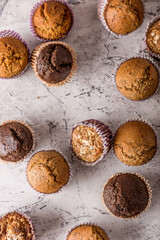 Sweet cakes or cupcakes on light marble background. Holiday cake celebration, delicious dessert, close up