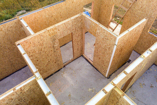 Construction of new and modern modular house. Walls made from composite wooden sip panels with styrofoam insulation inside. Building new frame of energy efficient home concept.