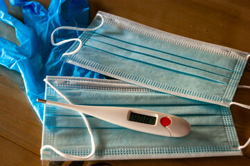 surgical masks, gloves and a fever thermometer