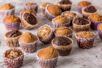 Sweet cakes or cupcakes on light marble background. Holiday cake celebration, delicious dessert, close up