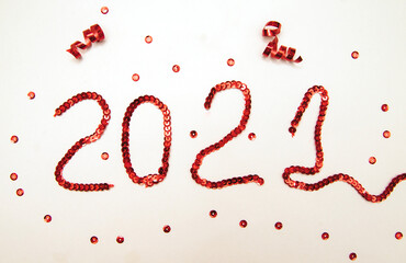 The inscription 2021 is lined with red sequins.New year's numbers.Christmas background.