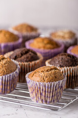 Sweet cakes or cupcakes on light marble background. Holiday cake celebration, delicious dessert, close up