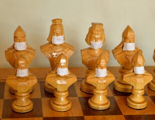 chess pieces in medical masks, sports and coronavirus