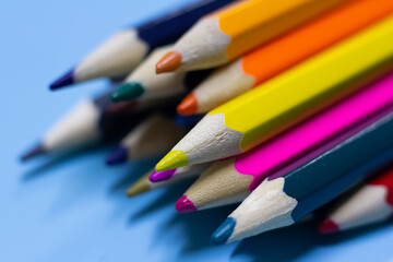 colored pencils on a blue background