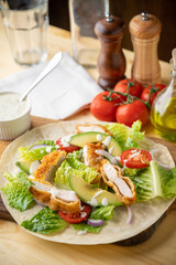 crispy chicken wrap on wooden board