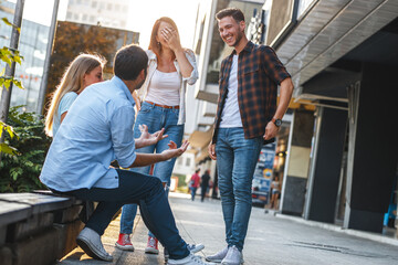 Group of young people hangout at the city street.