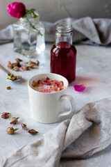 Pink moon milk with almond, rose essence and cardamom, fresh flower and dried buds. Healthy nondairy drink