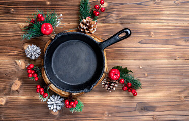 Vintage cast iron skillet on rustic wood background. Food background with copyspace. New Year and...