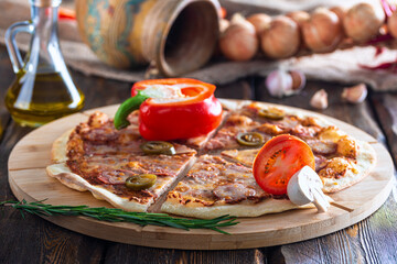 cutting board with hot tasty pizza and mushroom with oil bottle on wooden background,close view 