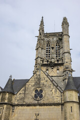 Fototapeta na wymiar Built in heart of Fecamp XVI century Saint-Etienne church dominates now wearing Norman city: Renaissance portal, flamboyant Gothic steeple. Fecamp, Seine-Maritime department, Haute-Normandie, France.