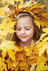 Naklejka na ściany i meble portrait of a girl in autumn leaves