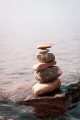 Fototapeta na wymiar Modern balance minimalism. Pebble geometric rock art. Organic balancing stones in water. 
