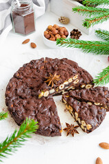 Fototapeta na wymiar Panforte. Traditional Italian Christmas dessert with nuts and dried fruit on a white background. Vertical, copy space.
