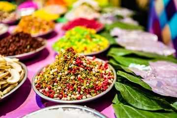different types of colorful garnish pan masala used to decorate betel leaf banarasi paan.