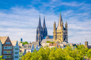 Fototapeta na wymiar View of historical city centre with towers of Cologne Cathedral of Saint Peter, Great Saint Martin Roman Catholic Church buildings and roofs of colorful houses, North Rhine-Westphalia, Germany
