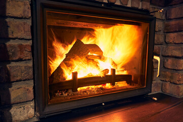 fireplace and fire close view as object or background, brick wall