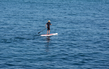 surfer paddling on his board